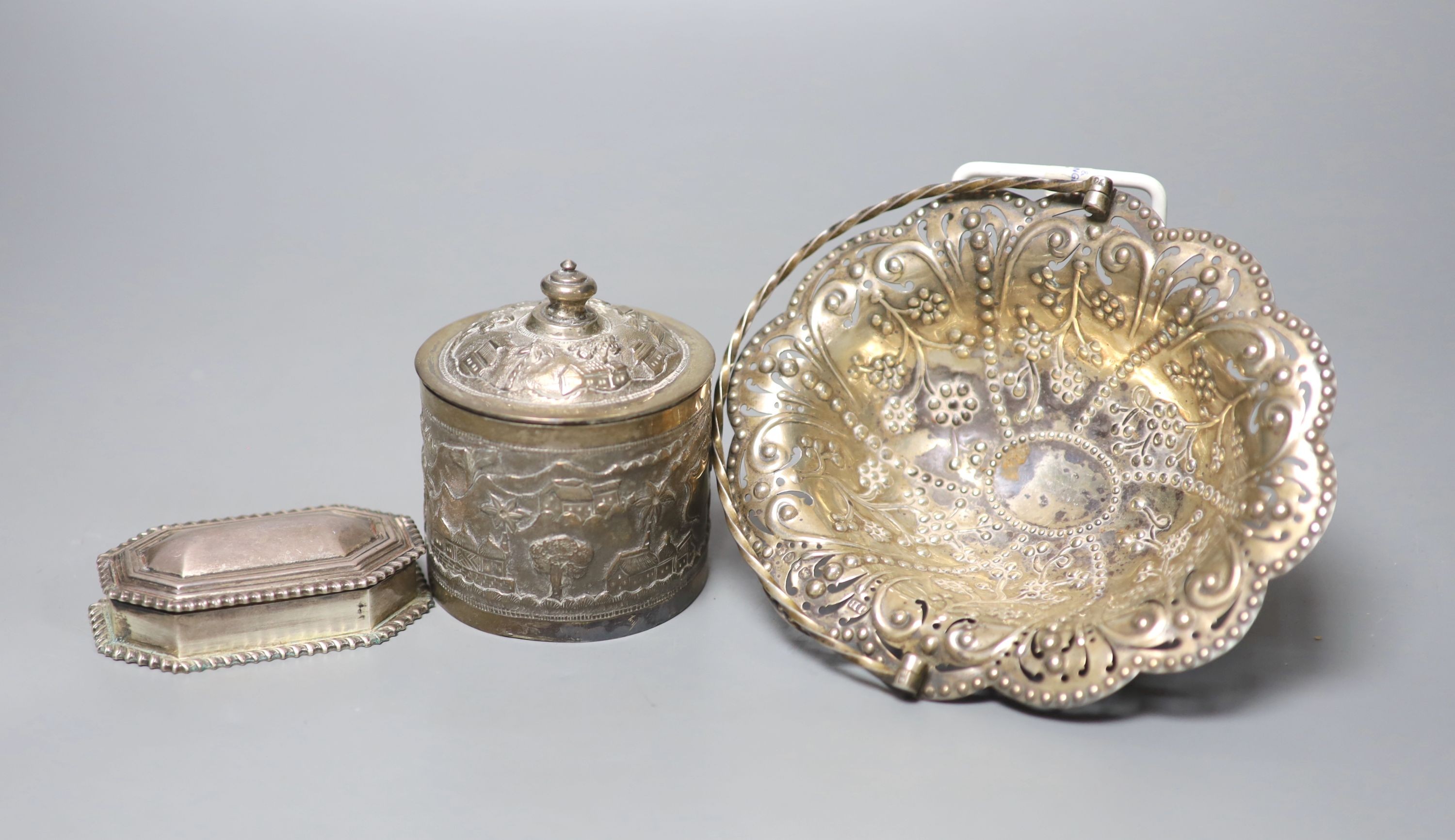 A late Victorian pierced silver basket, London, 1882, 15.7cm, a similar silver octagonal box and an Indian white metal box and cover.